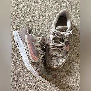 Grey/brown/pink Nike running shoes.
